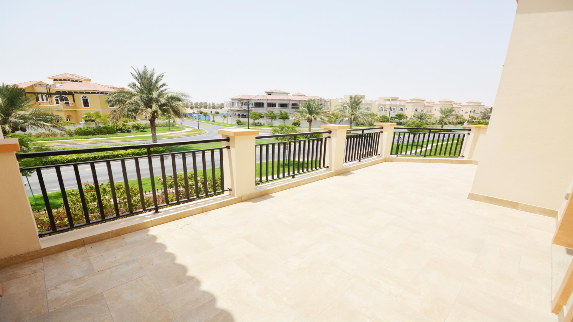 Lush garden in front of Spanish-style villa for rent in The Villa Community, Dubai