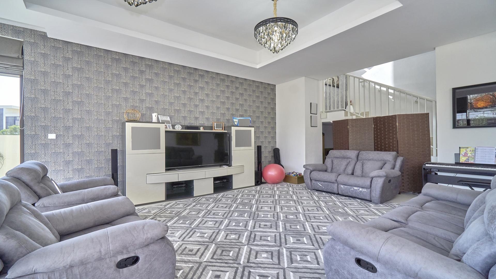 Luxurious living room in fully furnished villa, Damac Hills, with elegant decor and garden view