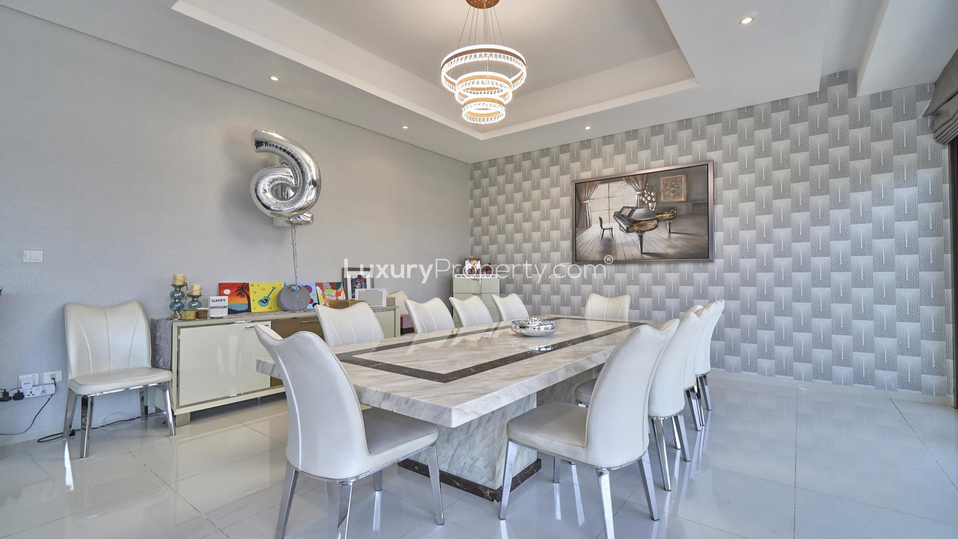 Luxury living room in furnished villa, Damac Hills, featuring modern decor and ample seating