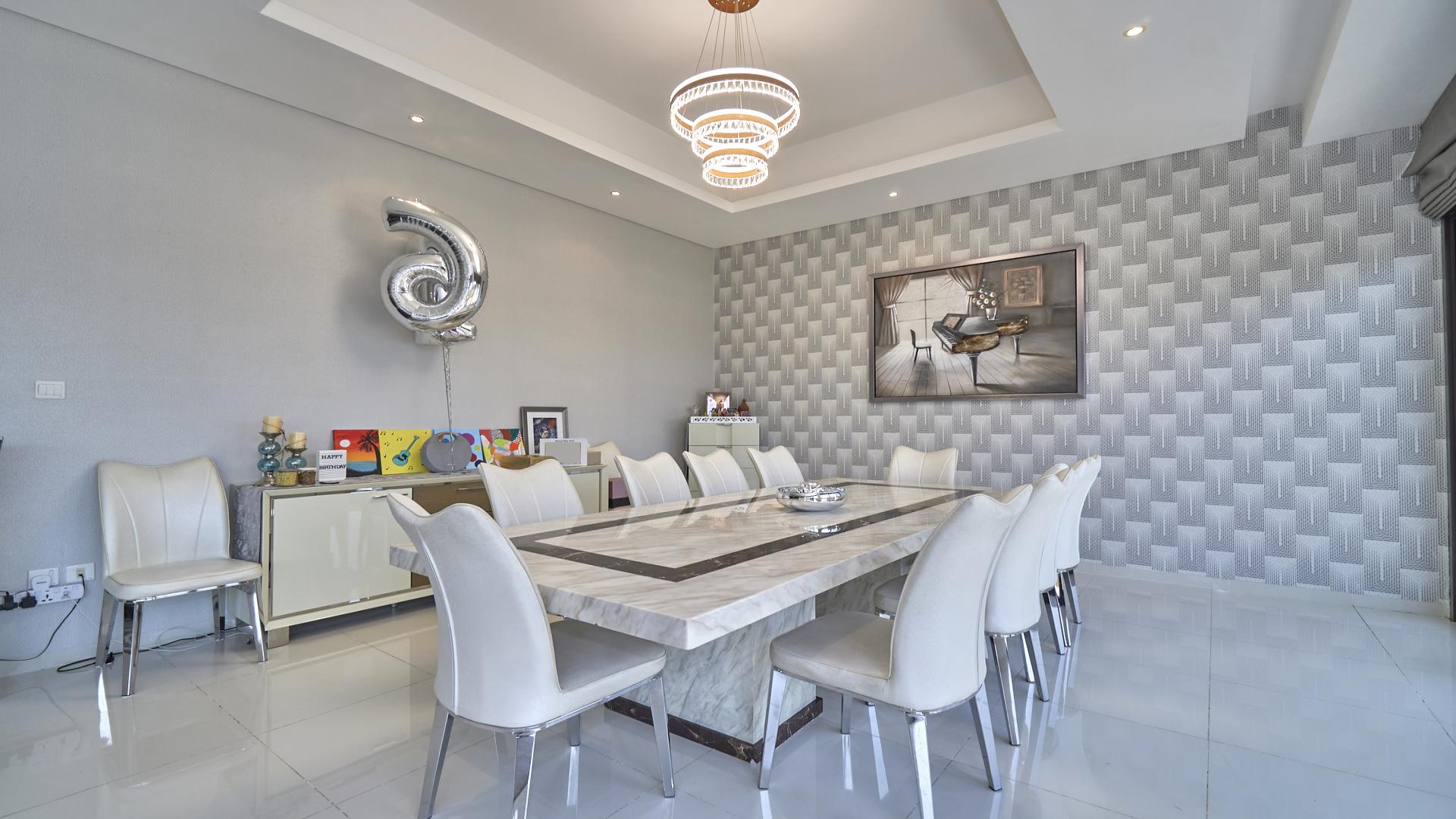 Luxury living room in furnished villa, Damac Hills, featuring modern decor and ample seating