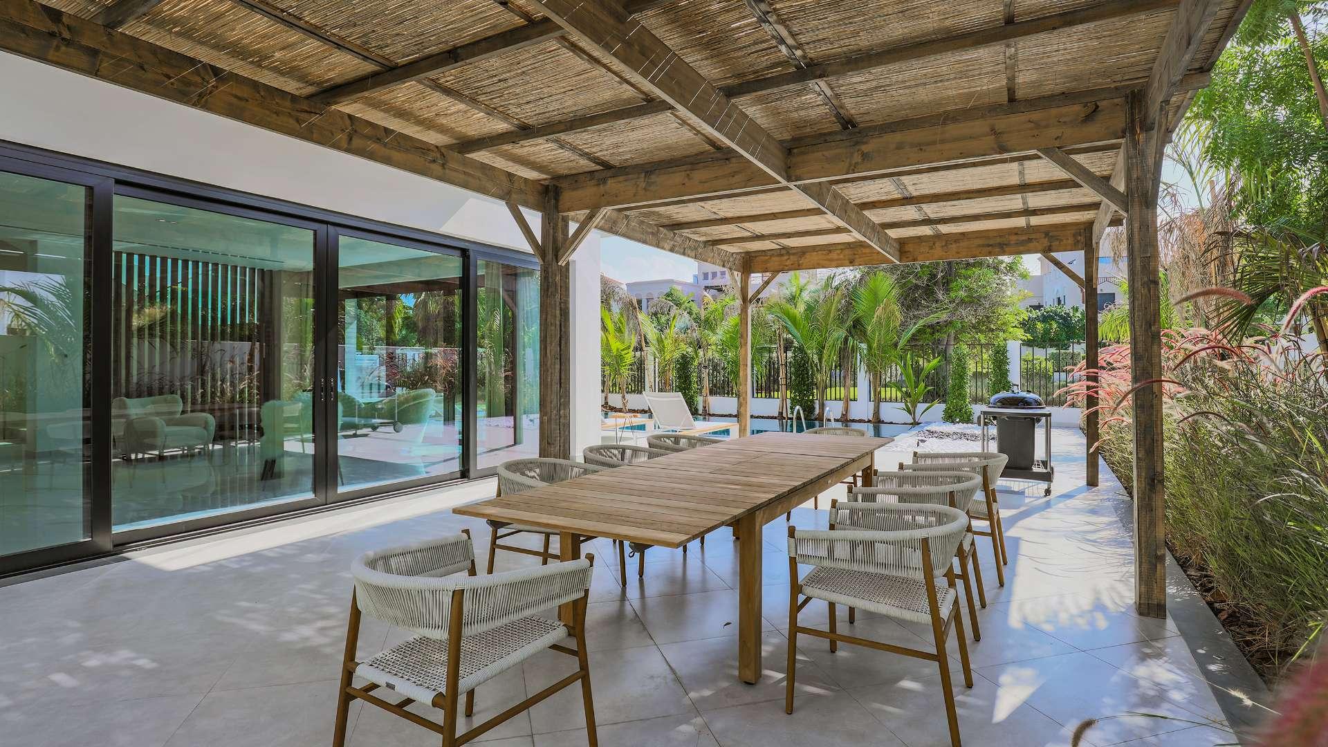 Luxurious living room in Al Barari villa with garden view and modern furnishings