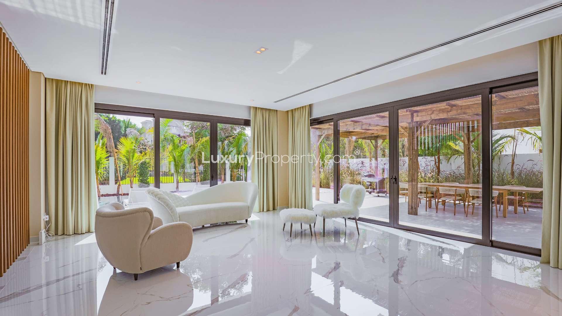 Brand new Al Barari villa with pool, modern exterior, and lush greenery in The Nest