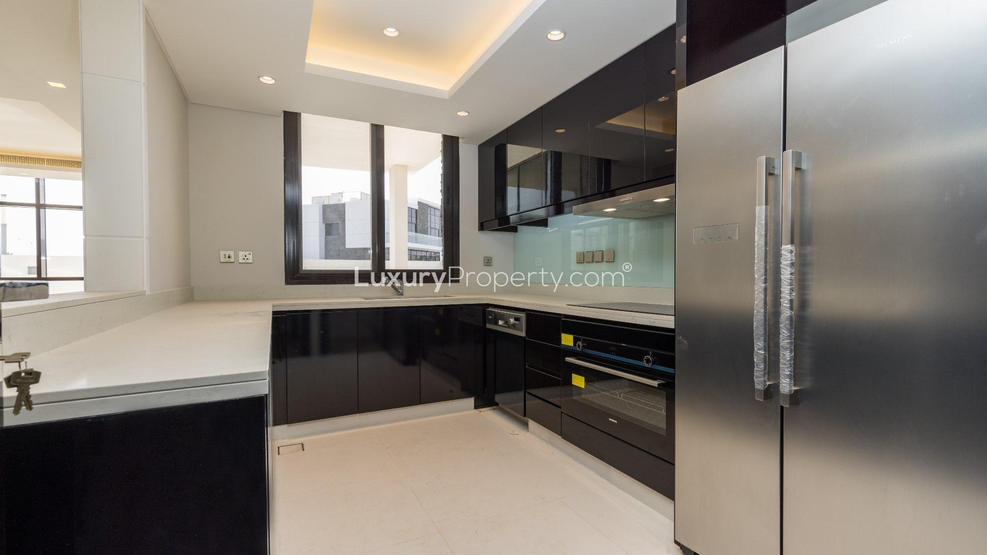 Spacious living area with large windows in modern villa at Trump Estates, Damac Hills