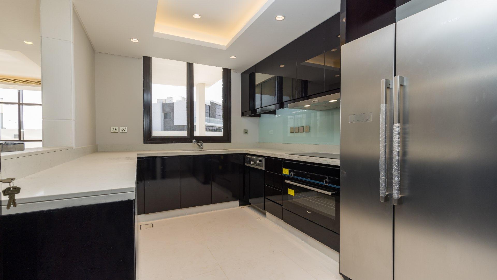 Spacious living area with large windows in modern villa at Trump Estates, Damac Hills