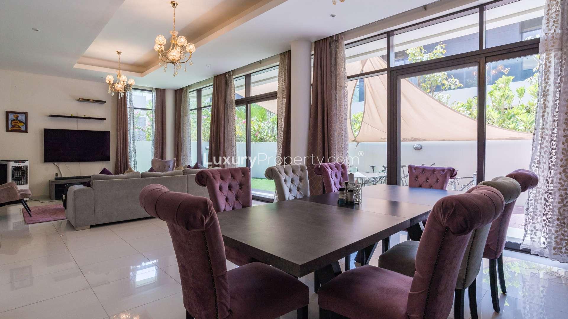 Luxurious villa poolside area with sun loungers and palm trees in Damac Hills, Whitefield