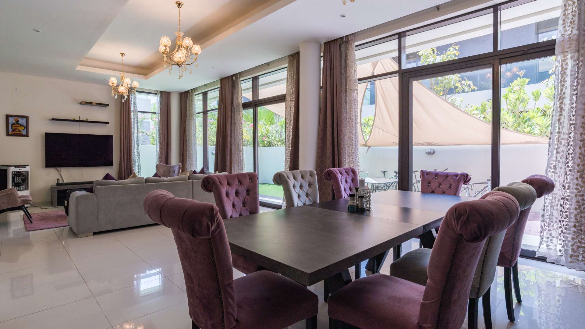 Luxurious villa poolside area with sun loungers and palm trees in Damac Hills, Whitefield