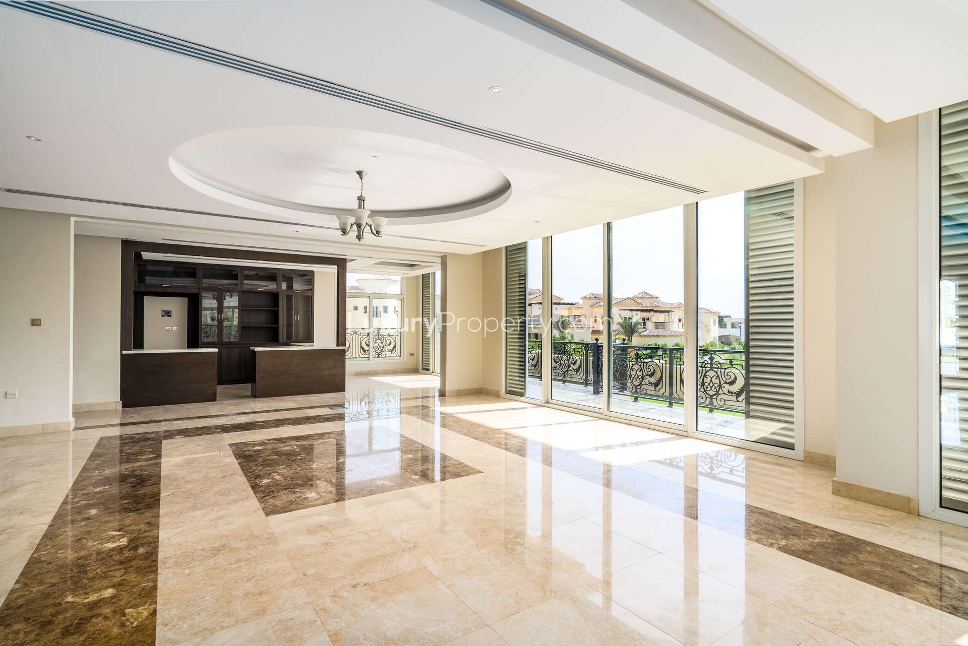 Spacious living area with large windows in Wildflower villa, Jumeirah Golf Estates