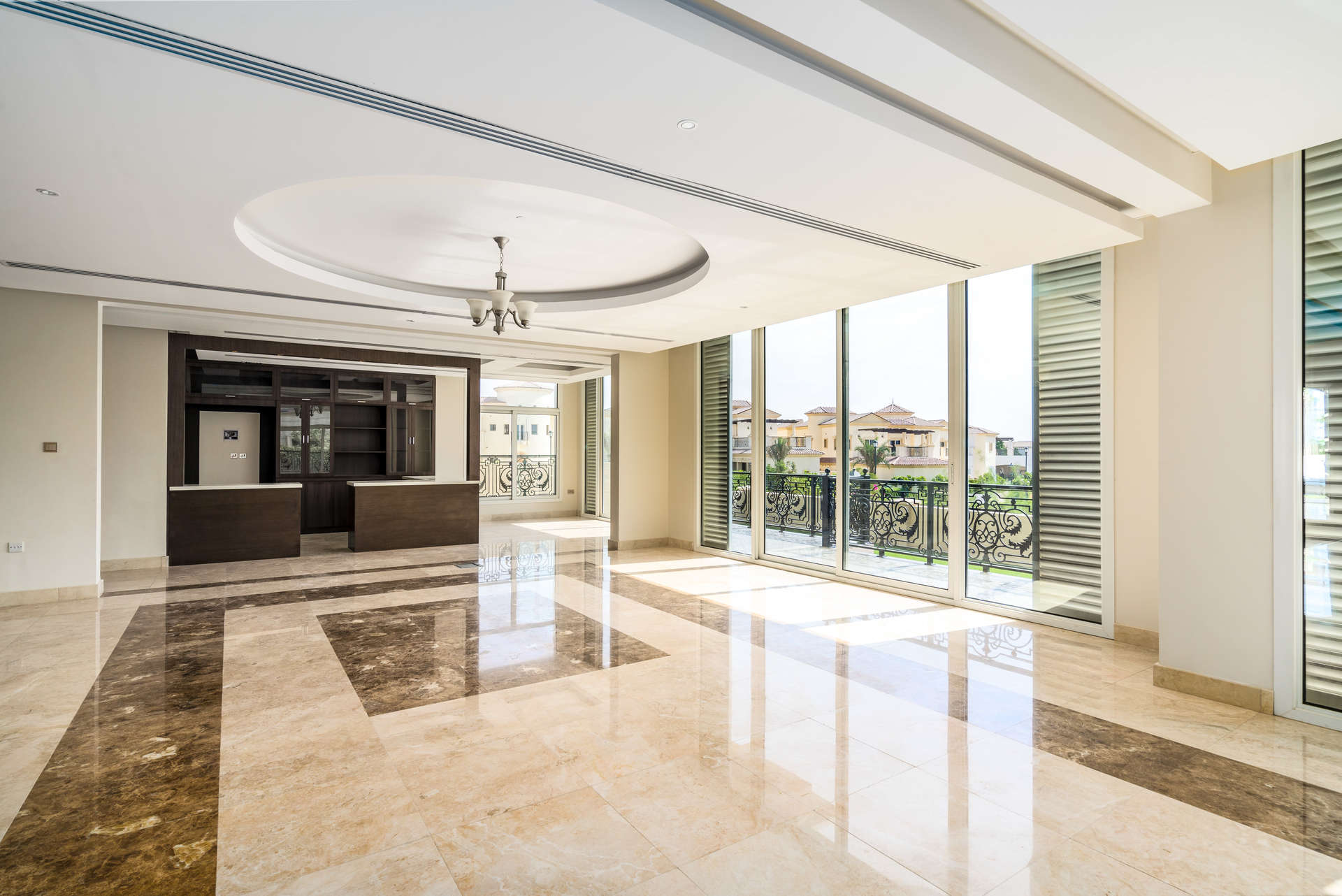 Spacious living area with large windows in Wildflower villa, Jumeirah Golf Estates