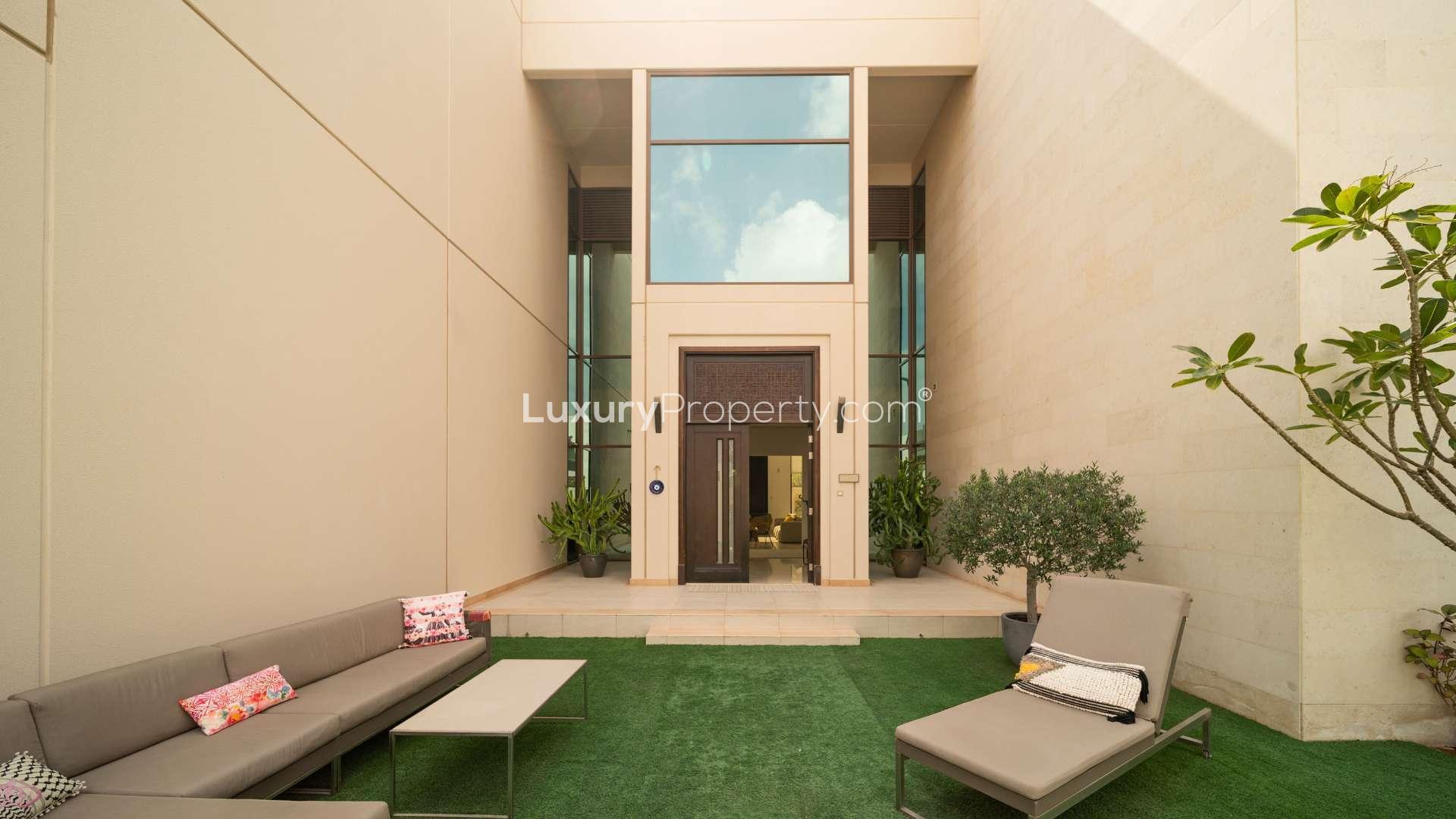 Elegant living room in 5-bedroom Meydan villa for sale, featuring modern decor and ample space