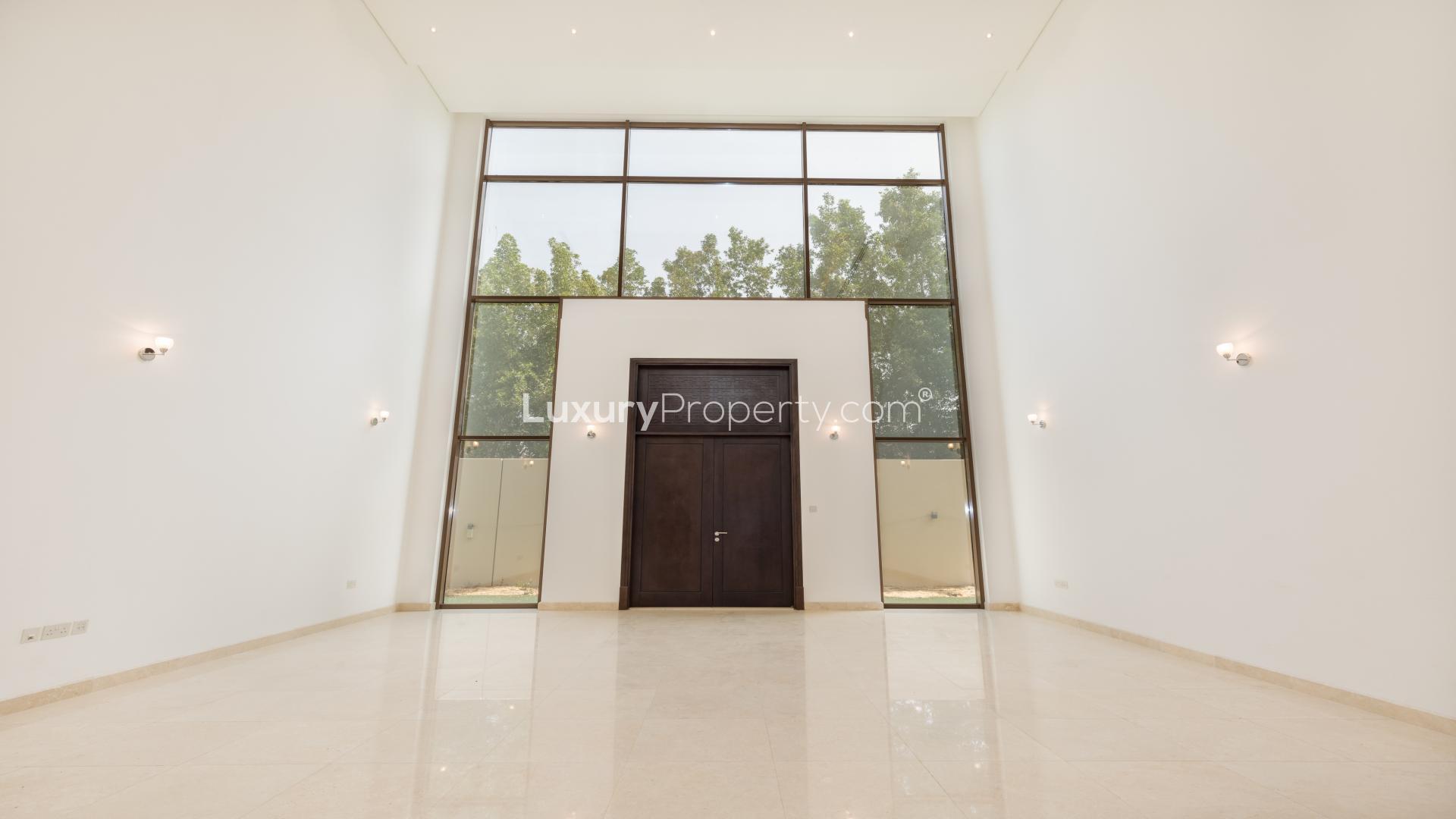 Spacious villa entrance with high ceilings and large windows in Meydan Gated Community