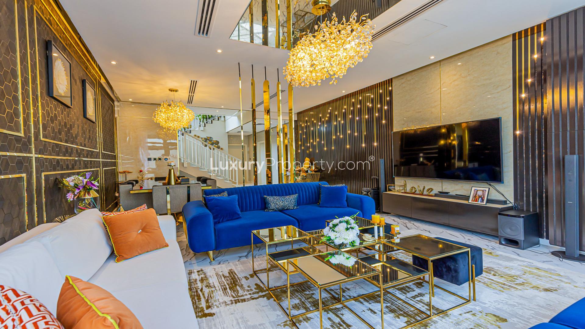 Luxurious living room in 5-bedroom villa, Damac Hills, featuring elegant decor and chandeliers