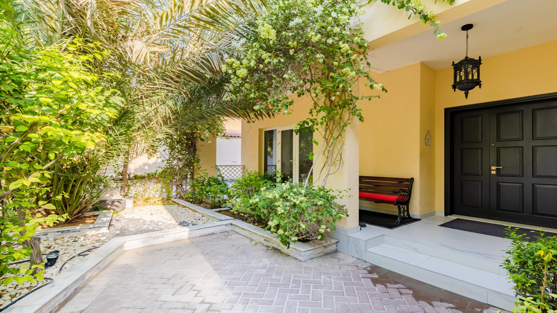 "Upgraded 5-bedroom villa with lush greenery in Green Community East, for sale.",Front entrance of upgraded villa with lush greenery in Green Community East