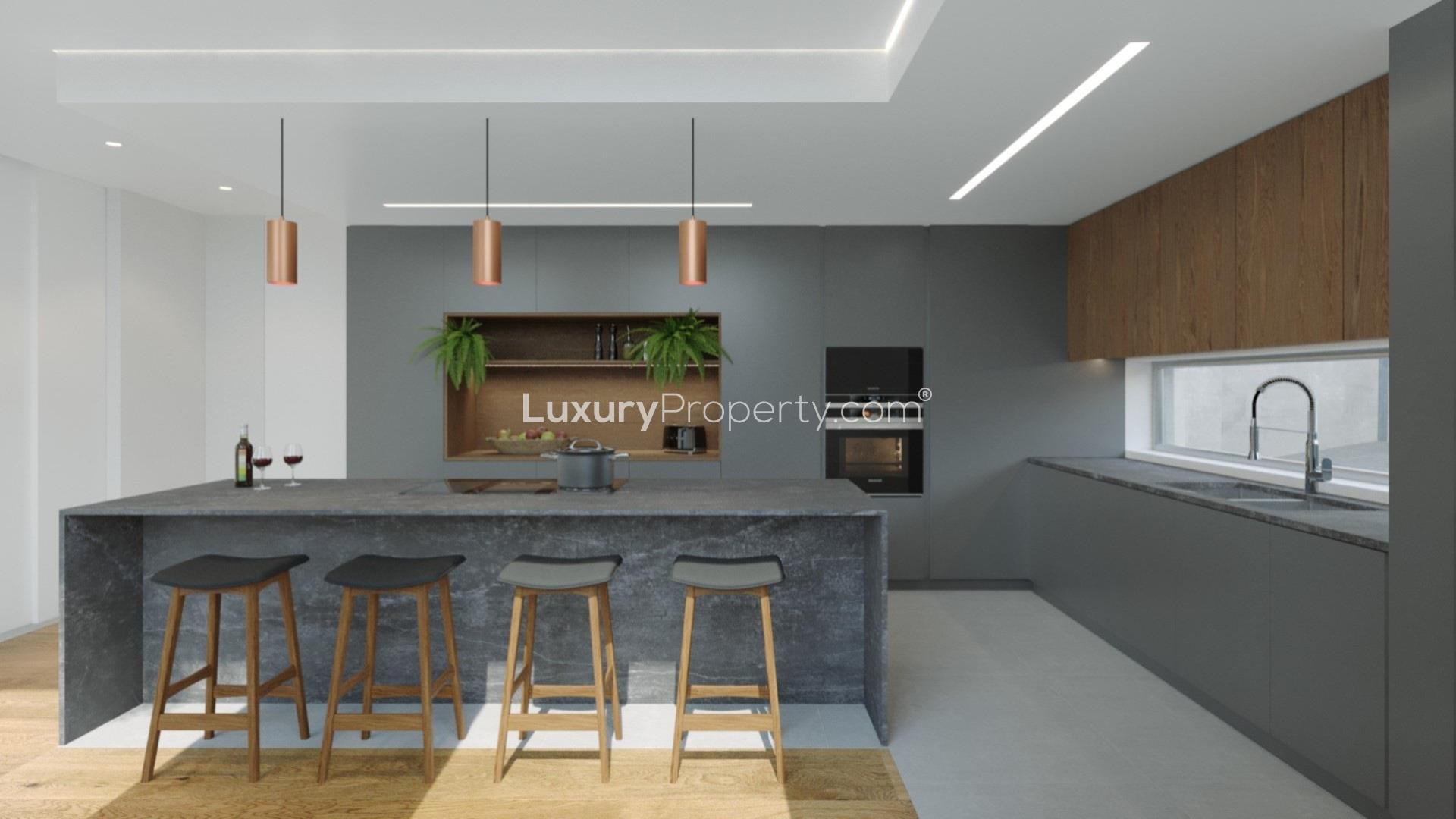 Bright dining and living area in Cascais villa with garden views and modern decor