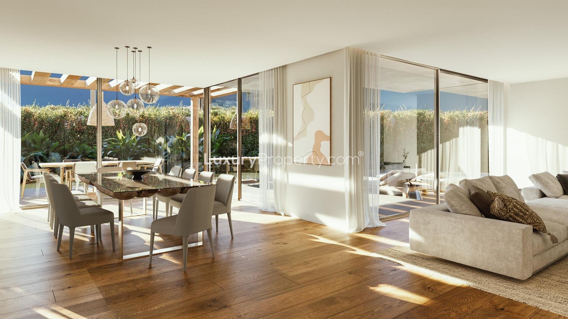 Modern living room with fireplace and garden view in Cascais villa for sale