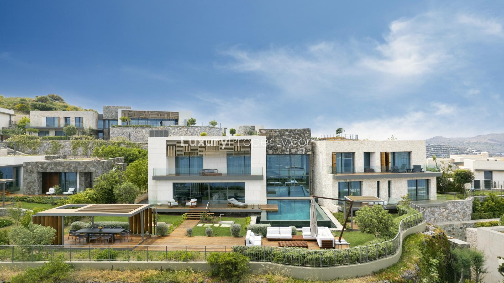 Luxurious villa exterior at night, Ritz-Carlton Residences Bodrum, elegant lighting and terraces