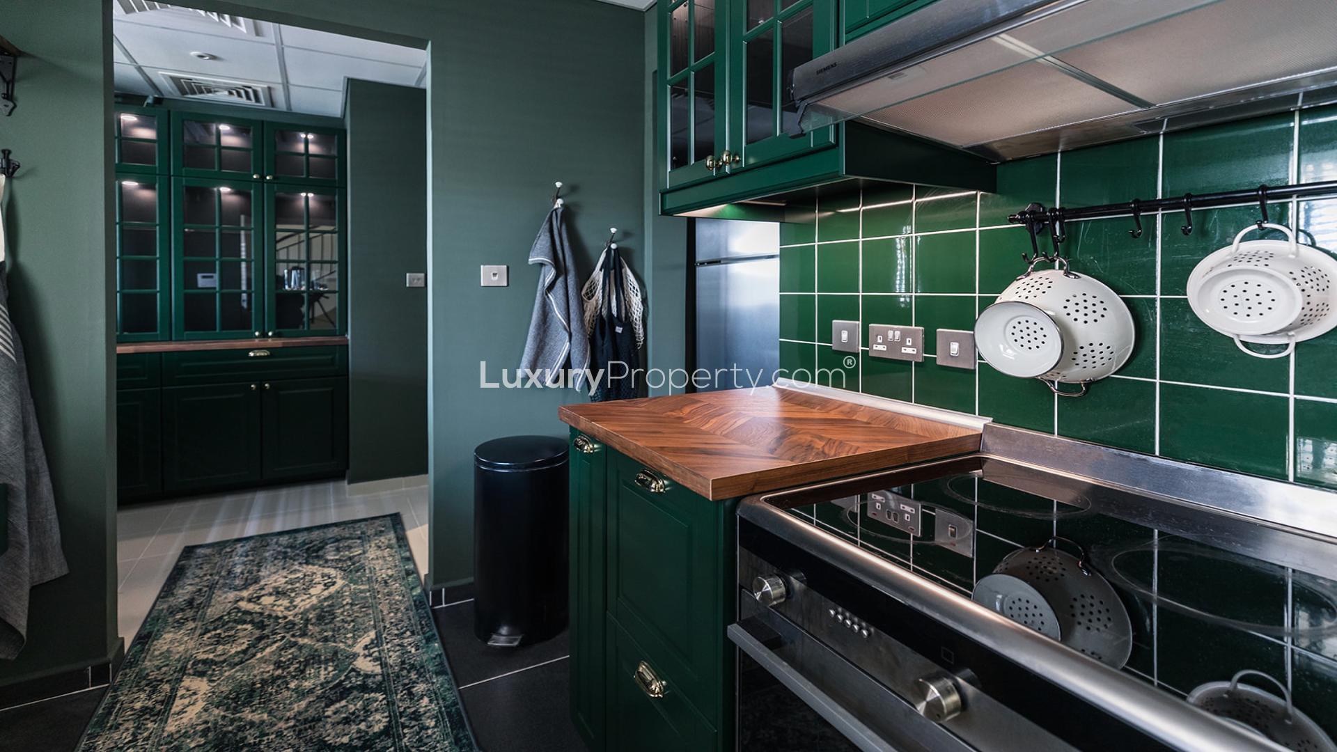 Modern kitchen with green cabinets in Damac Hills 2, Aurum Villas, villa for sale