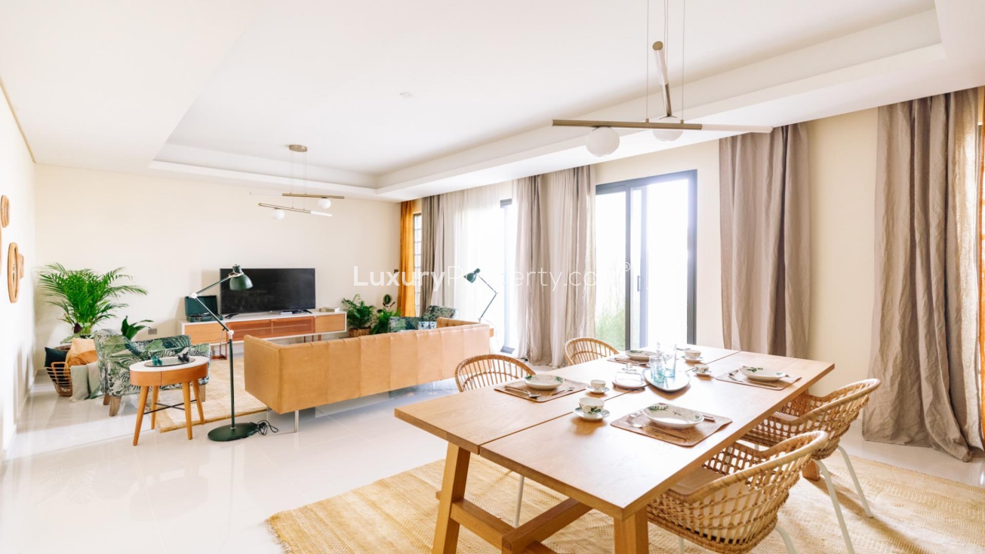 Modern living room in Aurum Villas, Damac Hills 2, featuring stylish decor and tropical mural