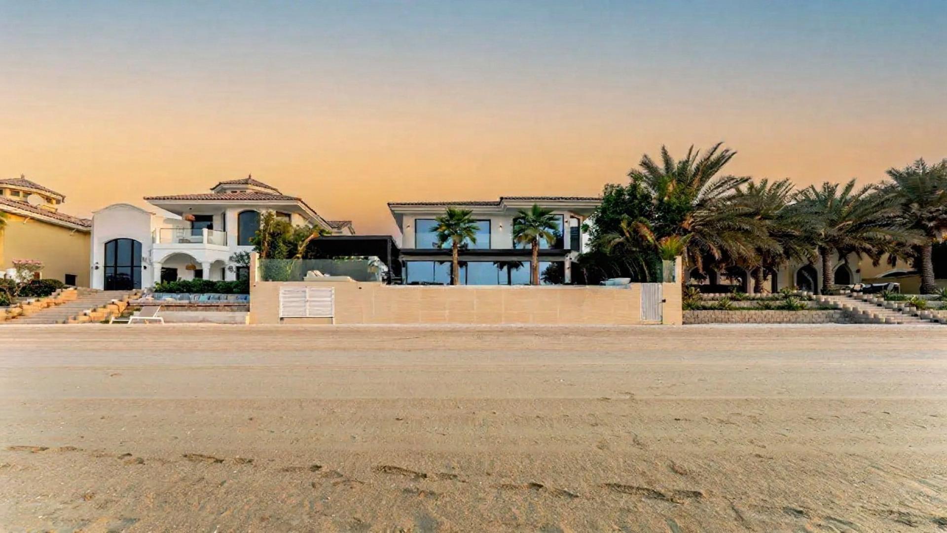 Luxurious Palm Jumeirah villa with pool, spacious patio, and lush garden for sale