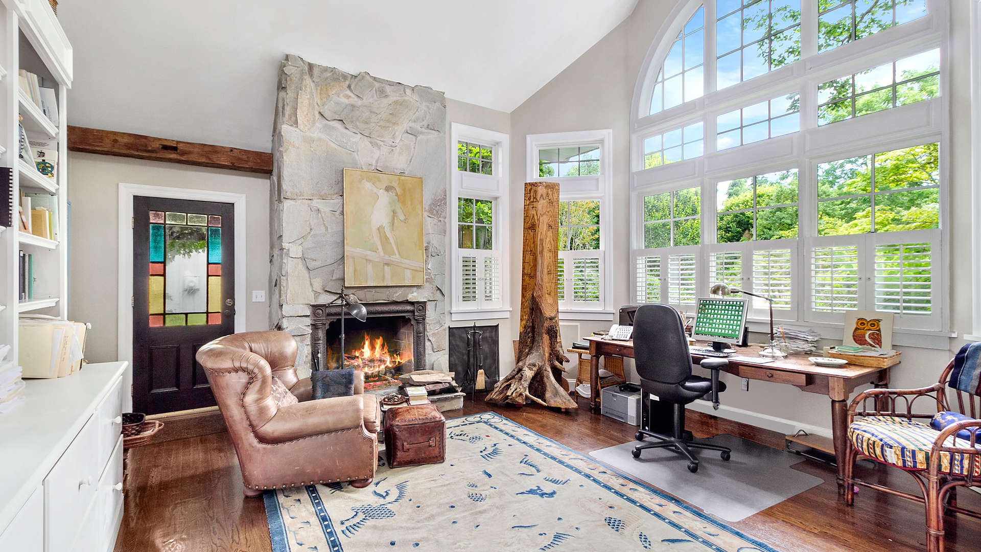 Elegant living room in five-bedroom Bridgehampton villa, featuring high ceilings and large windows