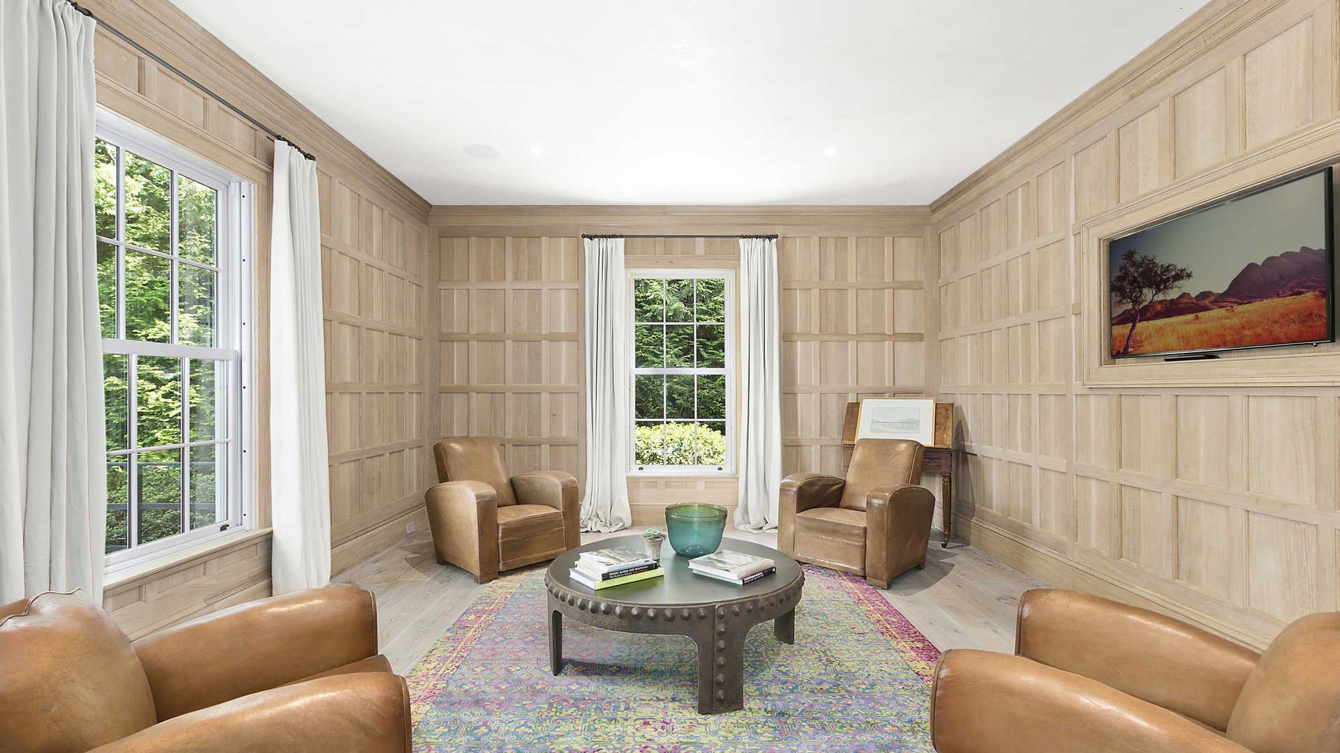 Modern classic-style living room in Sag Harbor villa, featuring elegant decor and natural light