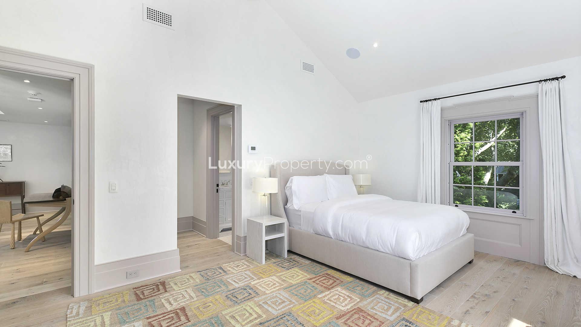 Elegant living room in Sag Harbor villa with leather chairs and large windows