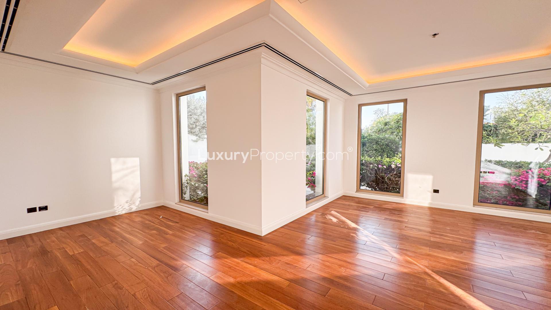 "Luxurious Camellia Villa patio with pool in Al Barari, for sale, extended plot.",Bright living area with wooden floors in Camellia Villa, Al Barari, for sale