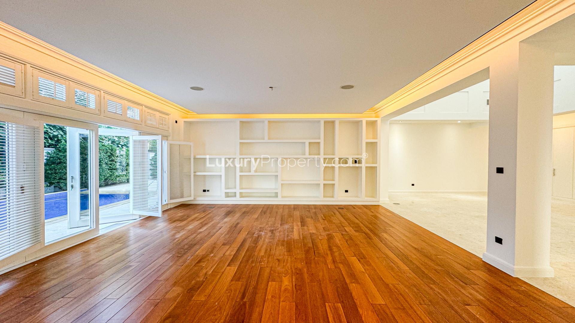 Spacious living area with wooden floors in Camellia Villa, Al Barari, for sale