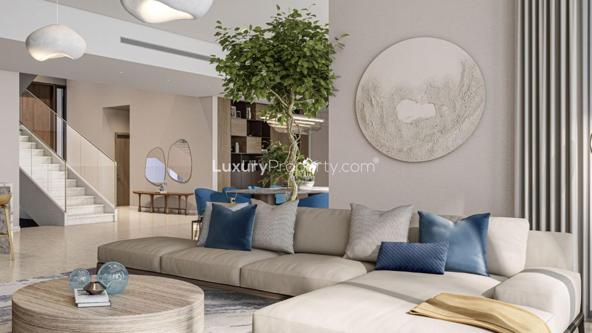 Modern living room in lagoon-facing villa, Dubai Hills Estate, with elegant furnishings and large windows