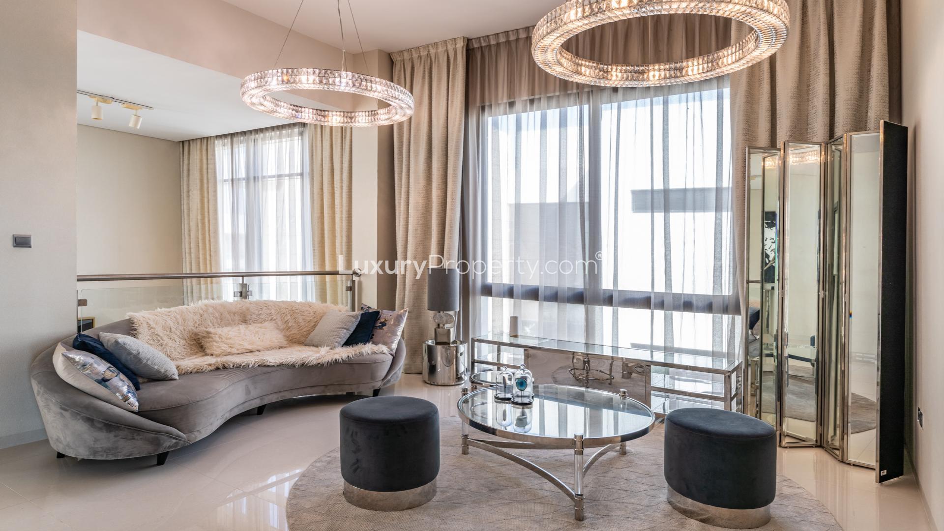 Luxury villa living room in DAMAC Hills with elegant decor and pool view