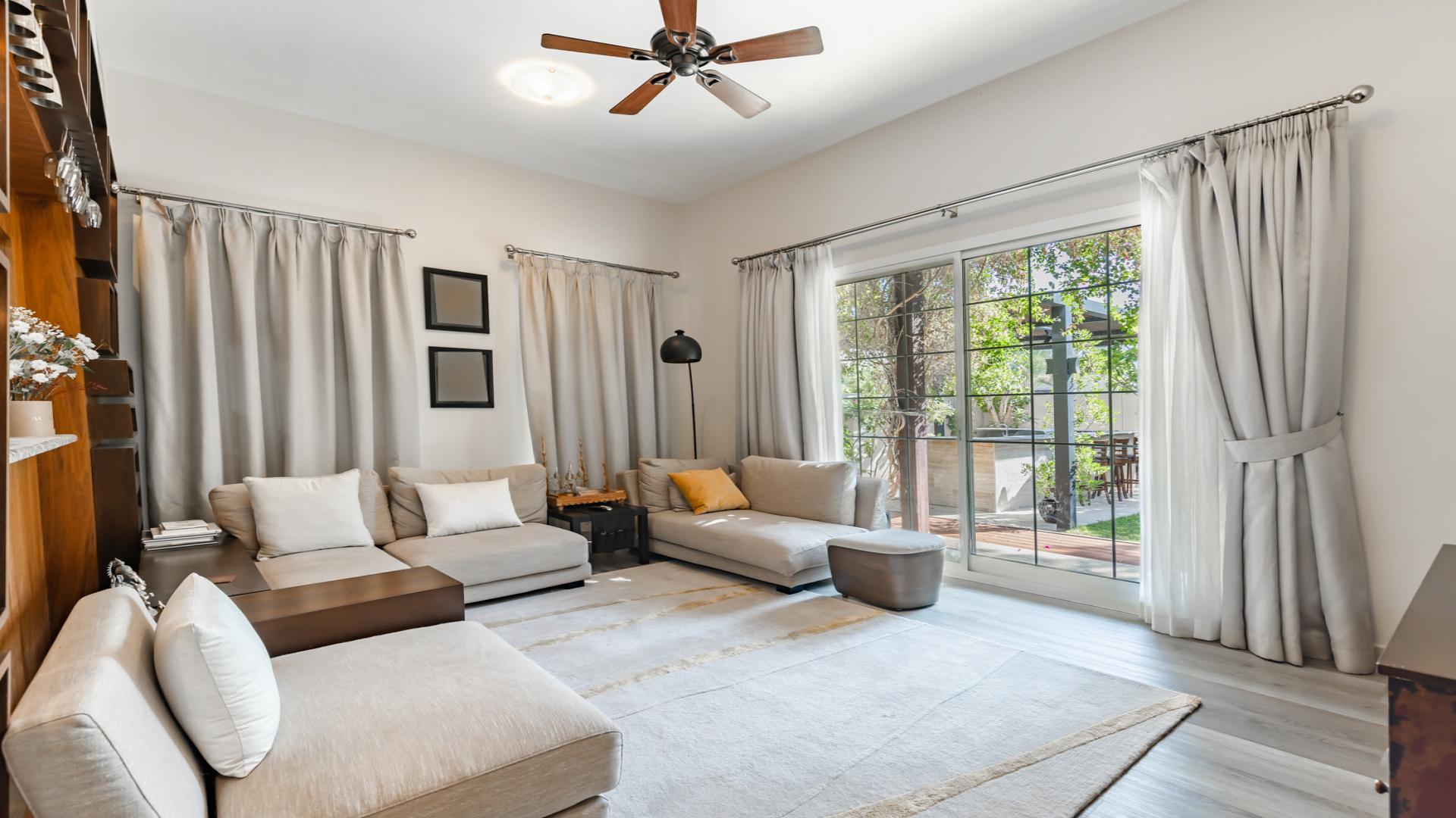 Elegant living room in Mudon Rahat villa for sale, featuring stylish decor and natural light