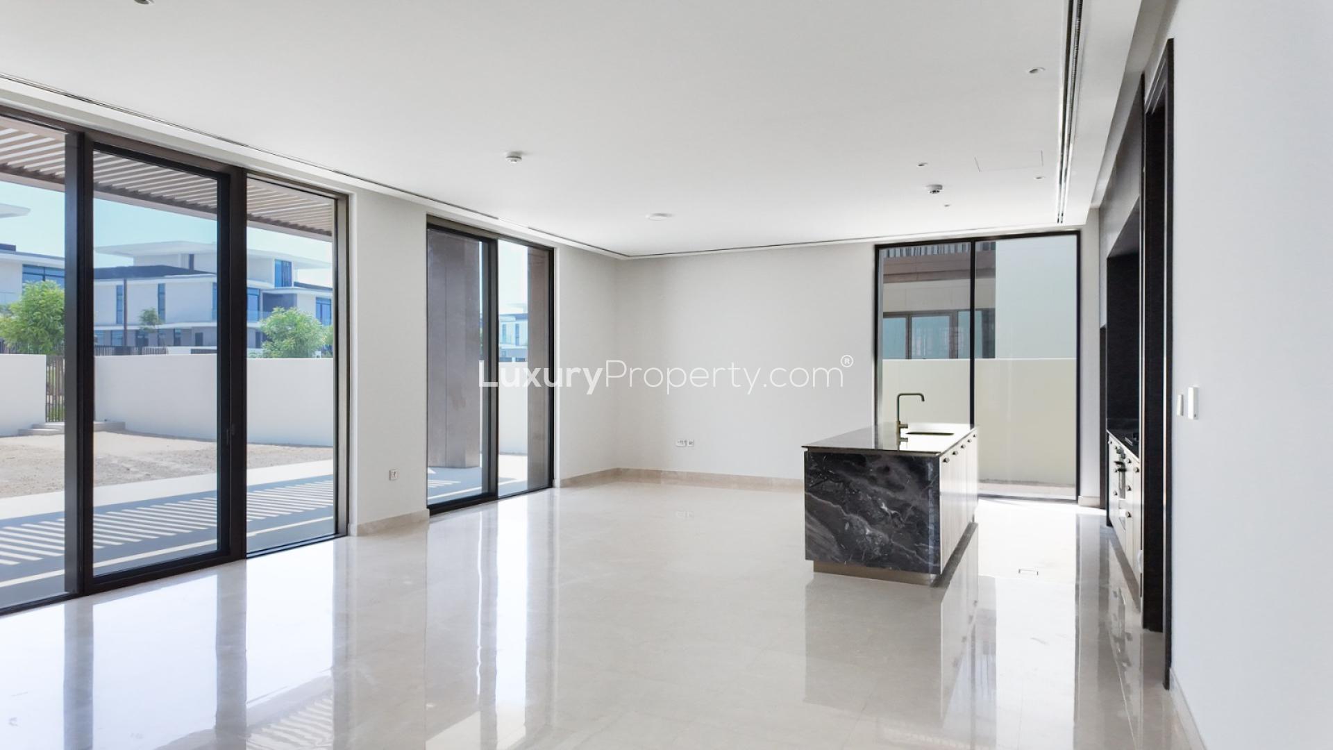 Modern living room in Dubai Hills Estate villa with large windows and natural light