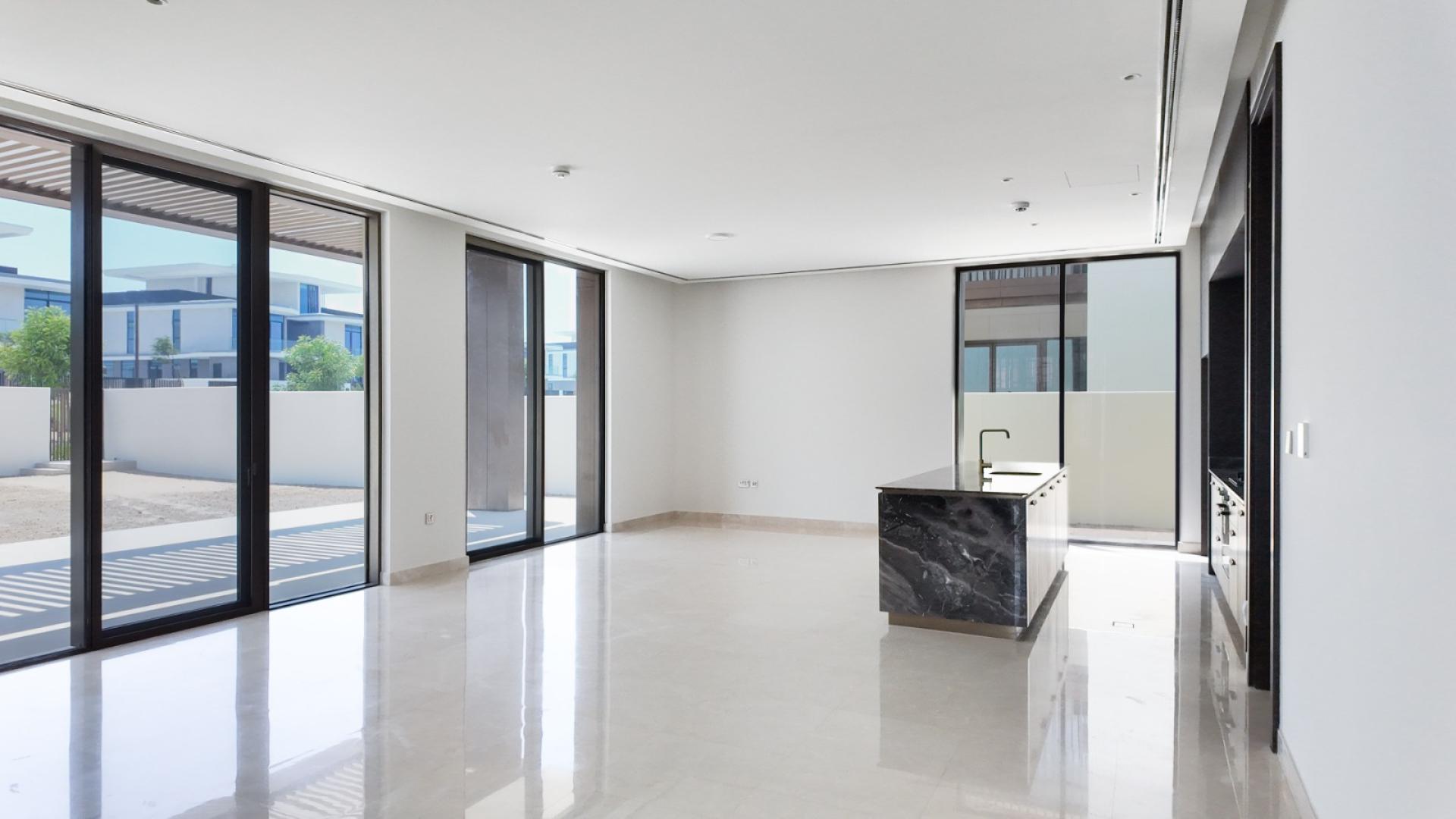 Modern living room in Dubai Hills Estate villa with large windows and natural light