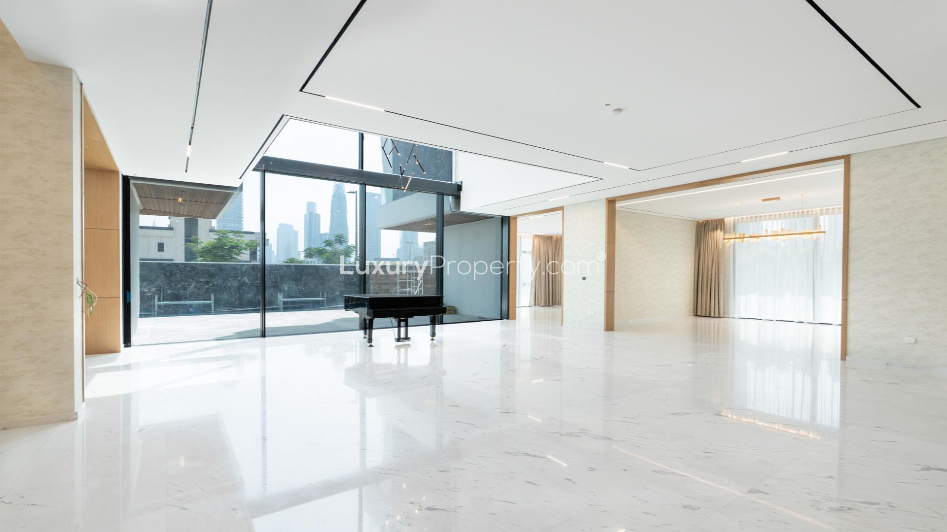 Luxurious Al Wasl villa interior with grand piano, marble flooring, and modern staircase