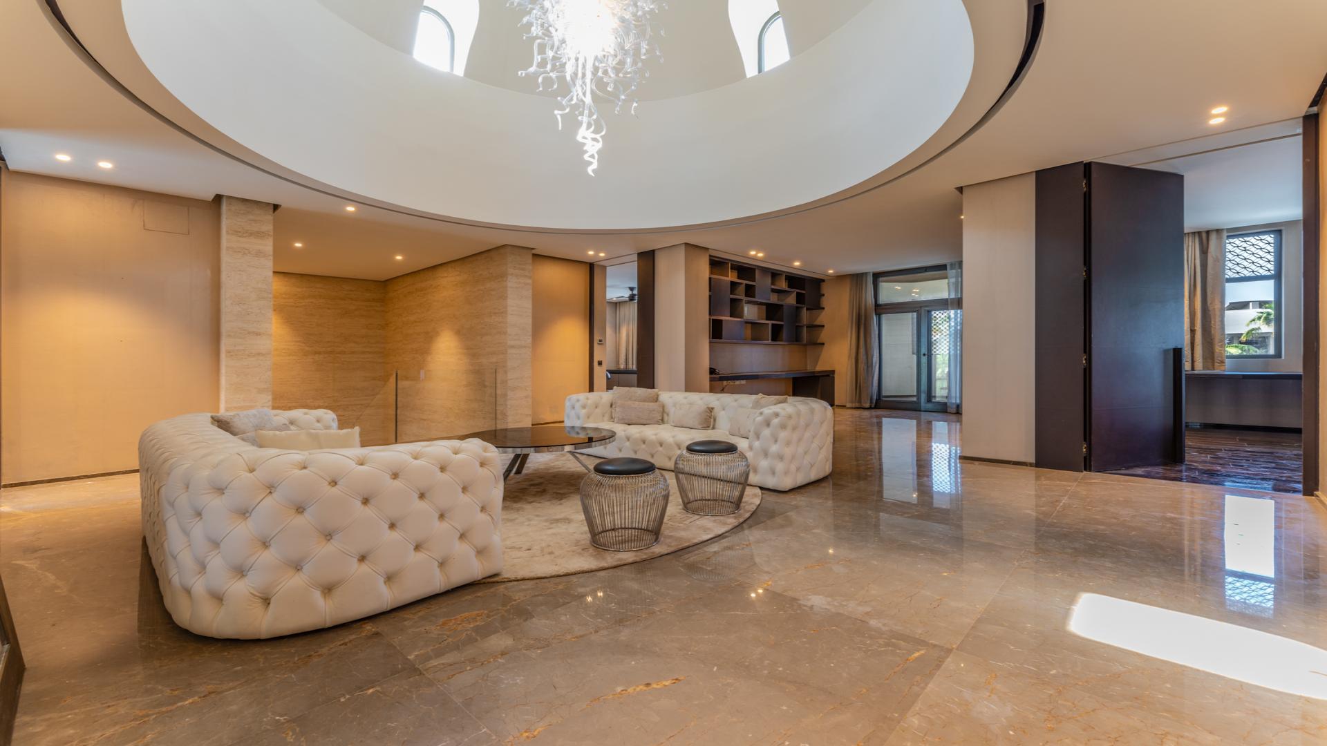 Elegant living room in 5-bedroom villa, Palm Jumeirah, featuring modern decor and stylish furniture