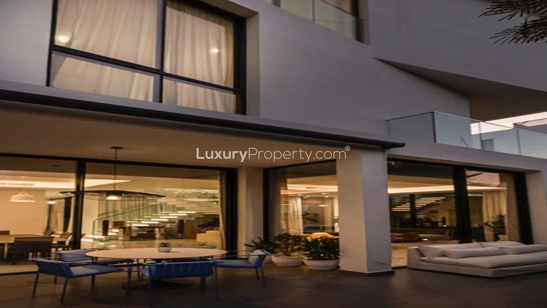 Modern villa exterior with lush greenery in Al Barari Villas, perfect for luxury living