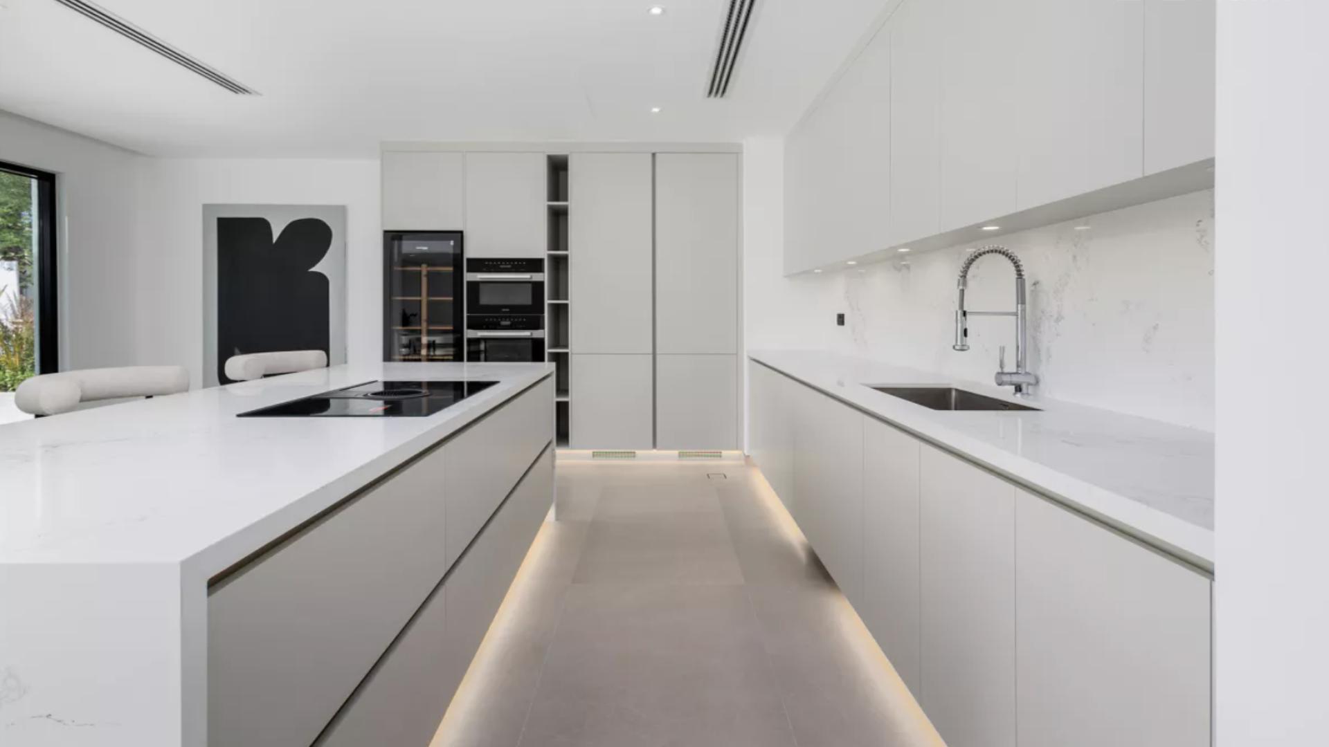 Modern living room with large windows in luxury Jumeirah Islands villa for sale