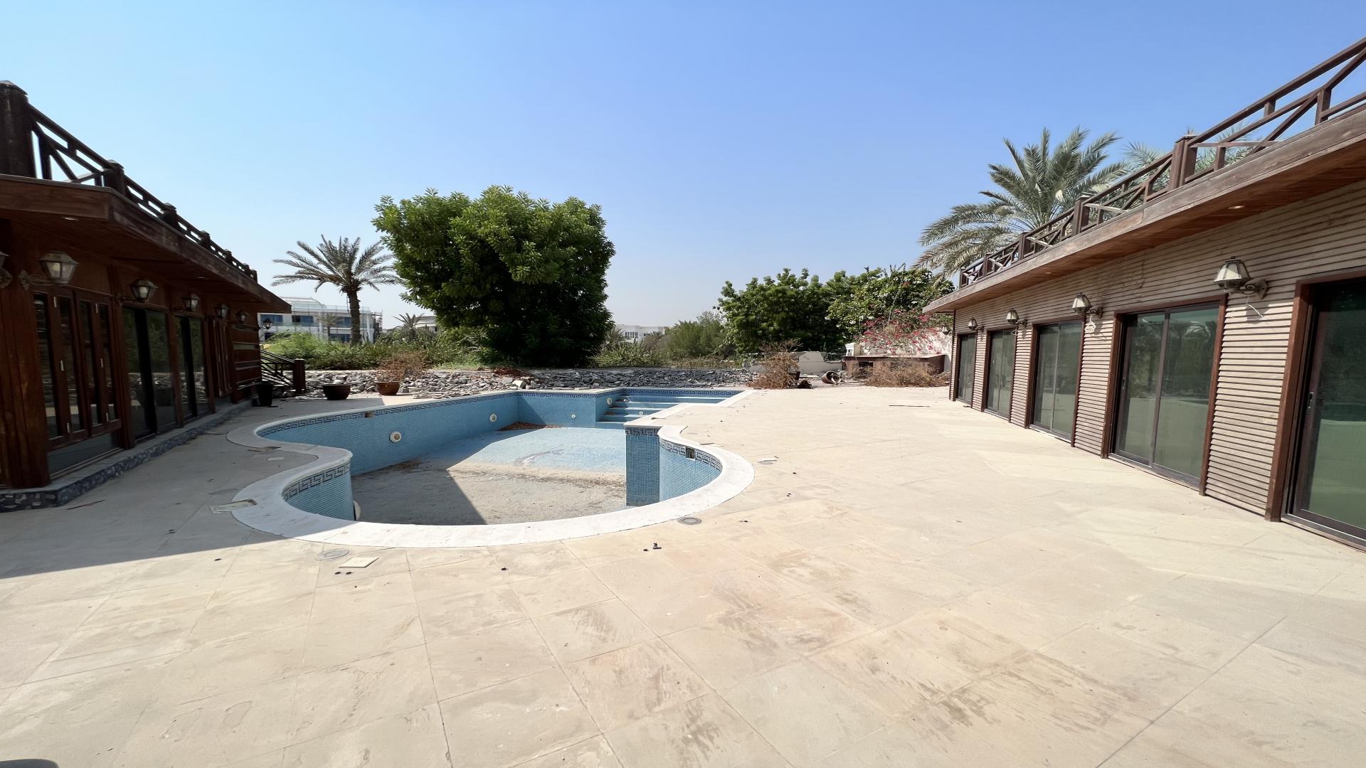 Luxury 5-bedroom villa with empty pool for sale in Emirates Hills, Sector R