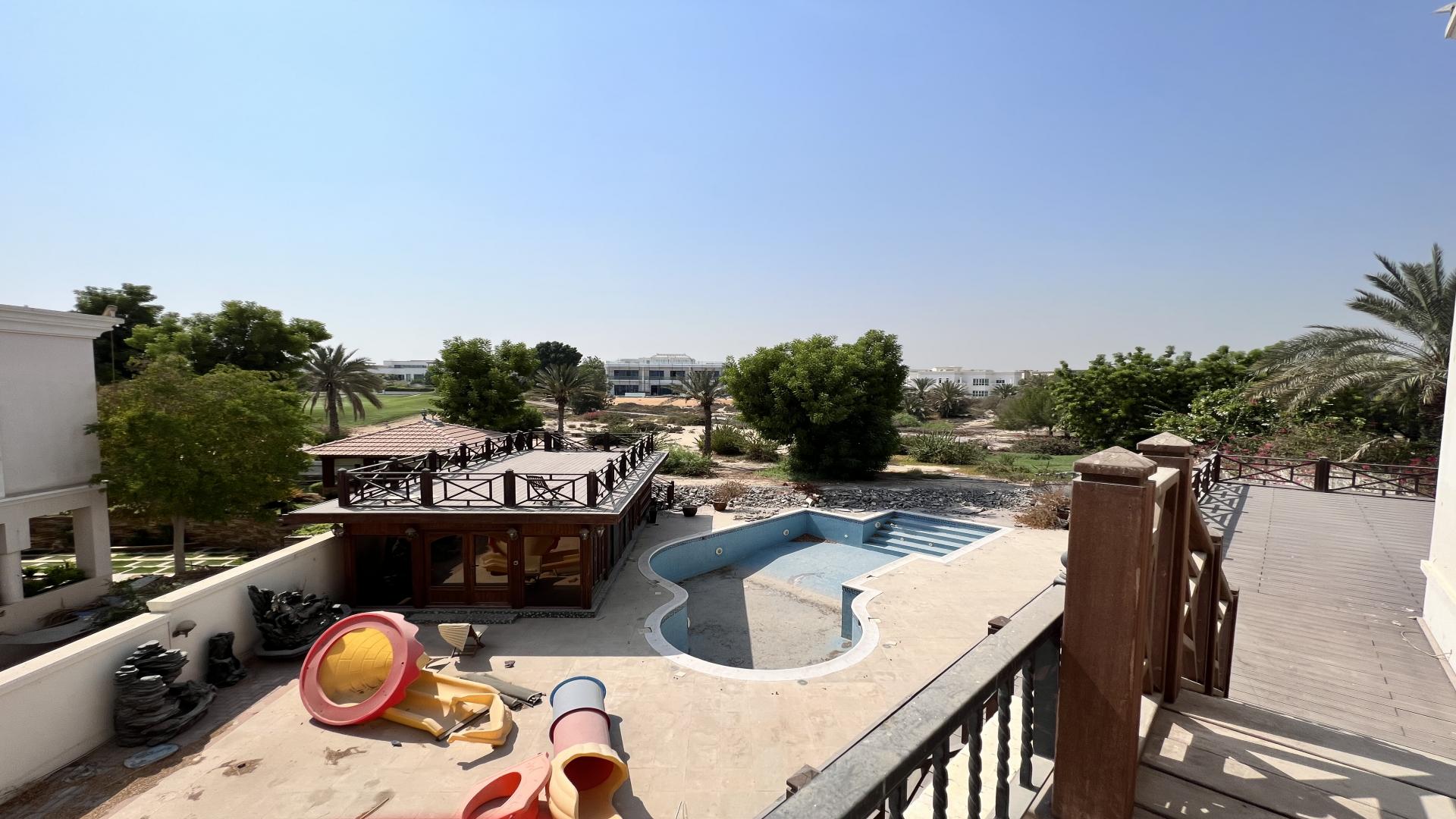 Backyard view of luxury villa with empty pool in Emirates Hills, Sector R