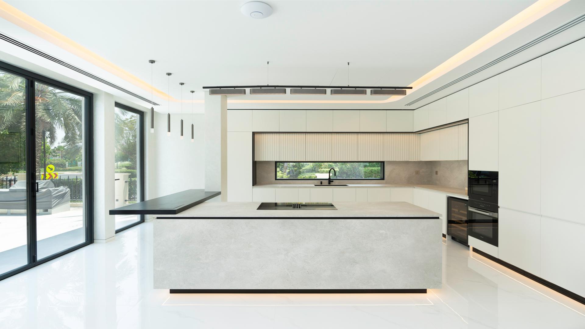 Modern furnished living room in Jumeirah Islands villa with elegant decor and large windows