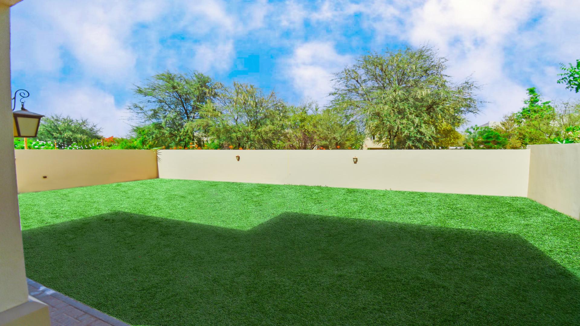 "Balcony view of garden and trees at new Aseel villa, Arabian Ranches for sale.","Spacious backyard of brand new villa in Aseel, Arabian Ranches, for sale.",Interior view of stairway and living area in Arabian Ranches villa, Aseel