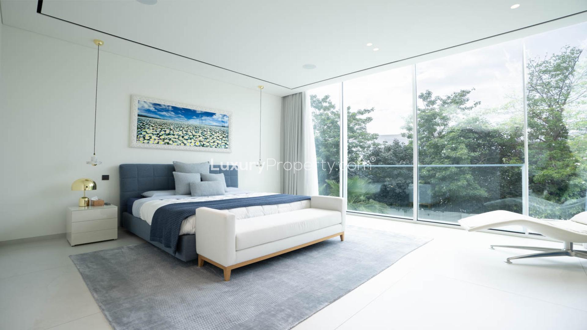 Luxury villa poolside view at The Nest, Al Barari, surrounded by lush greenery