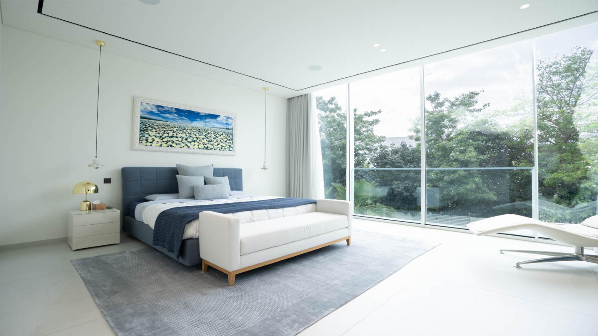 Luxury villa poolside view at The Nest, Al Barari, surrounded by lush greenery