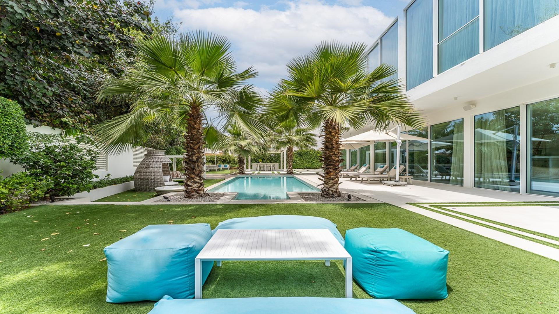 Luxury villa exterior with pool and patio in The Nest, Al Barari, Dubai