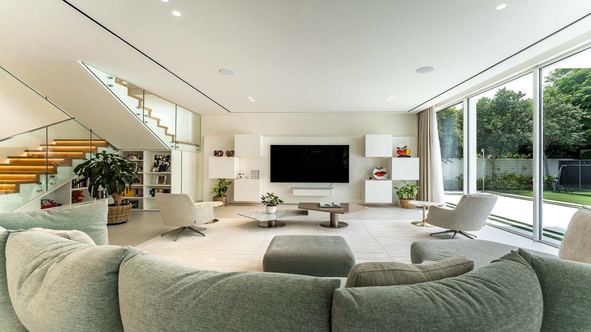 Luxurious living room in 5-bedroom villa at The Nest, Al Barari, featuring modern decor