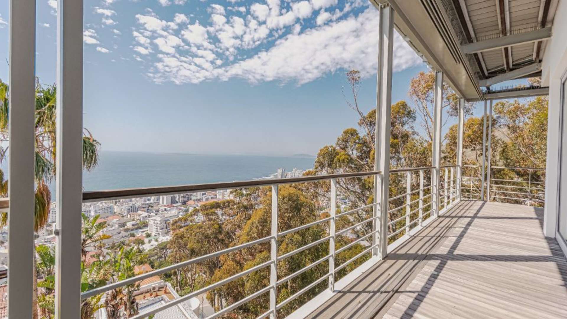 Luxurious living room in 5-bedroom Bantry Bay villa, Cape Town, with modern decor and balcony