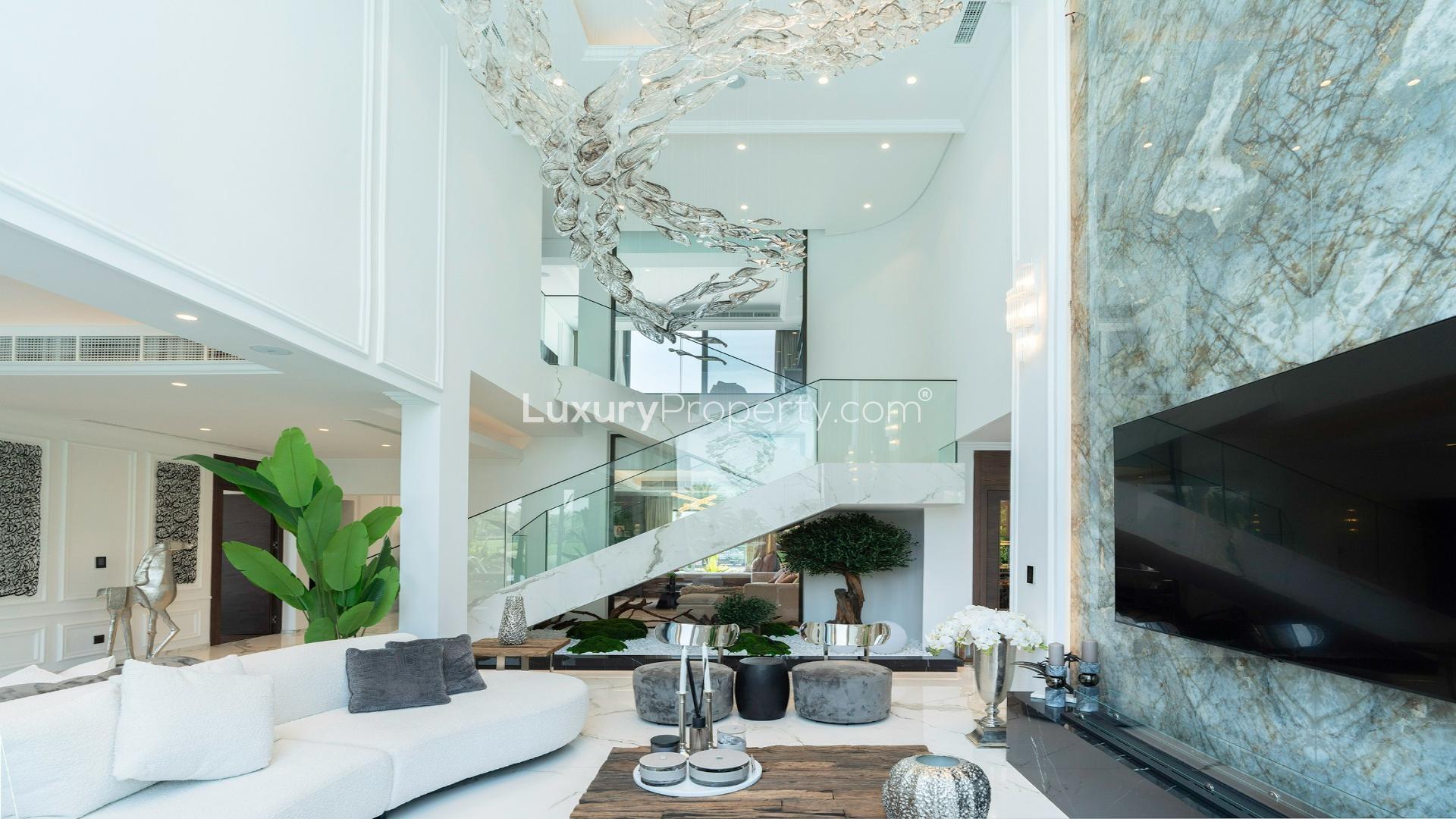 Luxurious villa living room with plush sofas, grand piano, and lake view in Jumeirah Islands