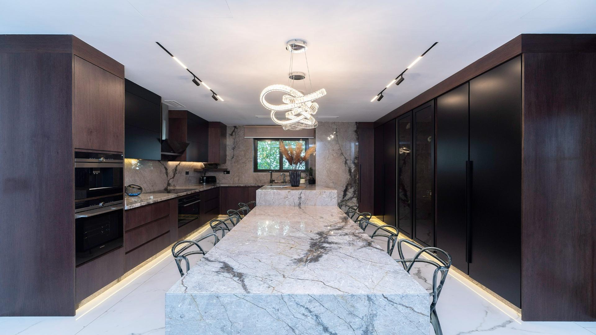 Modern villa interior with elegant decor, glass staircase, and spacious living area in Jumeirah Islands