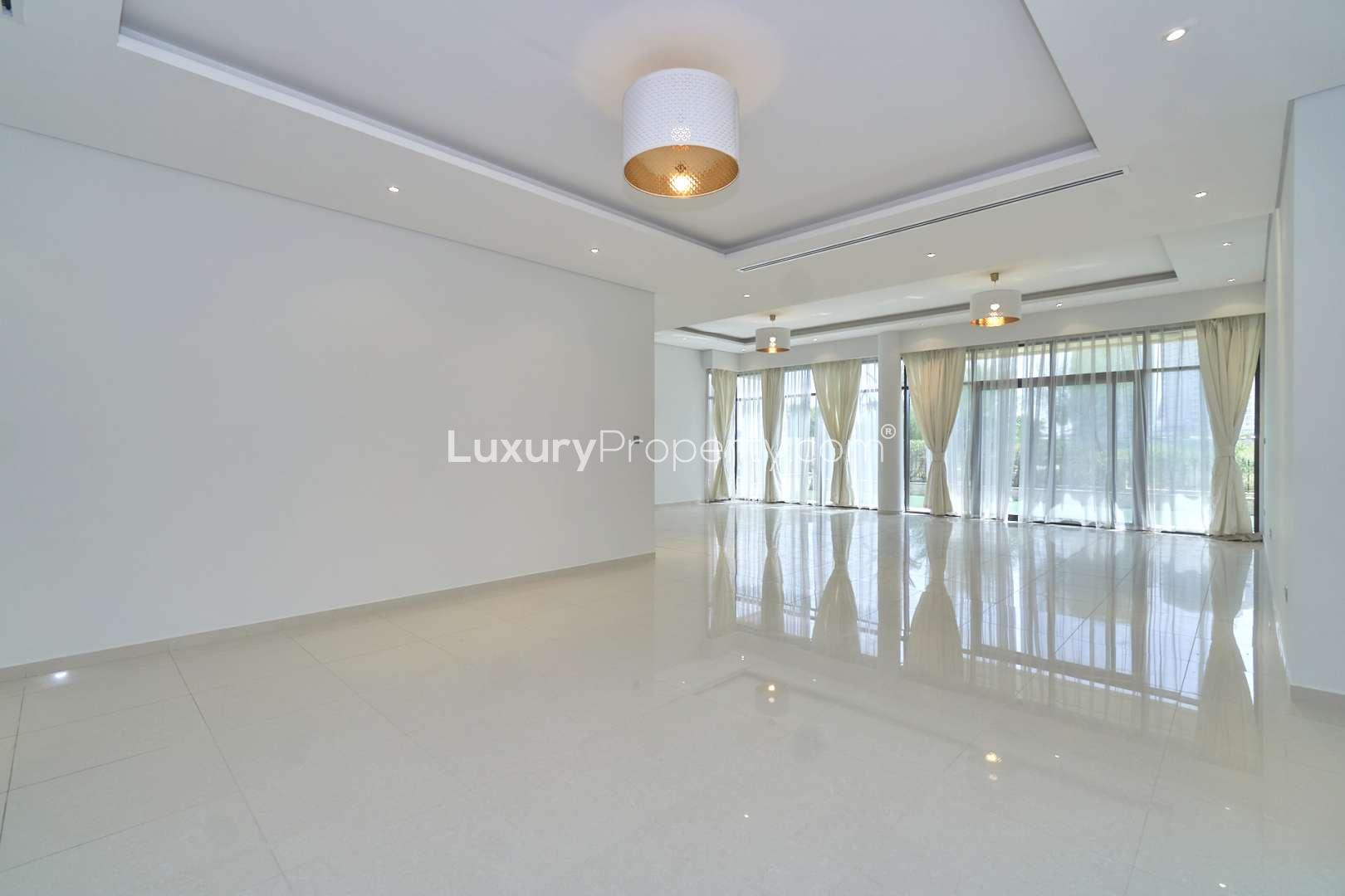 Empty bedroom with large window and curtains in Brookfield villa, Damac Hills