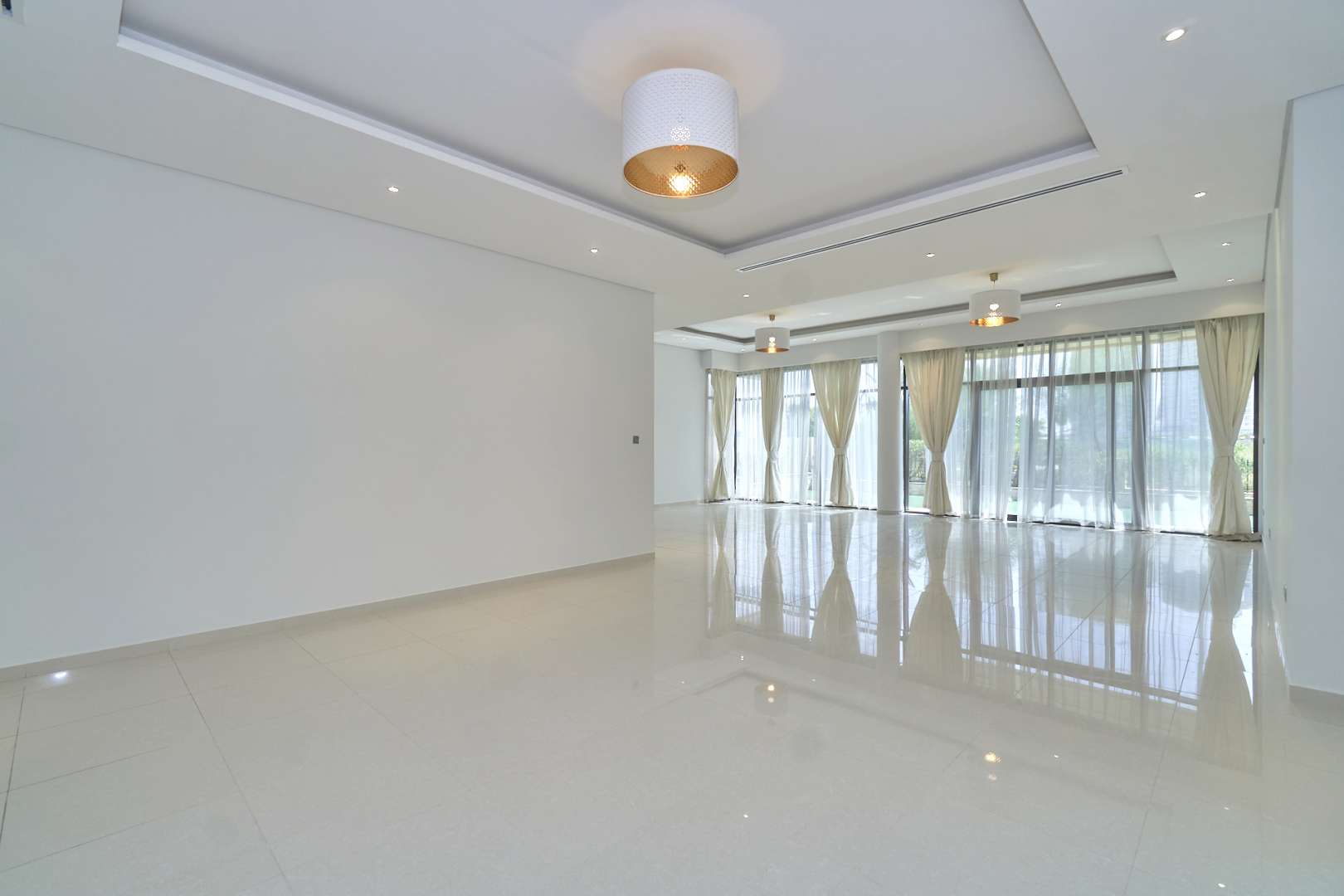 Empty bedroom with large window and curtains in Brookfield villa, Damac Hills