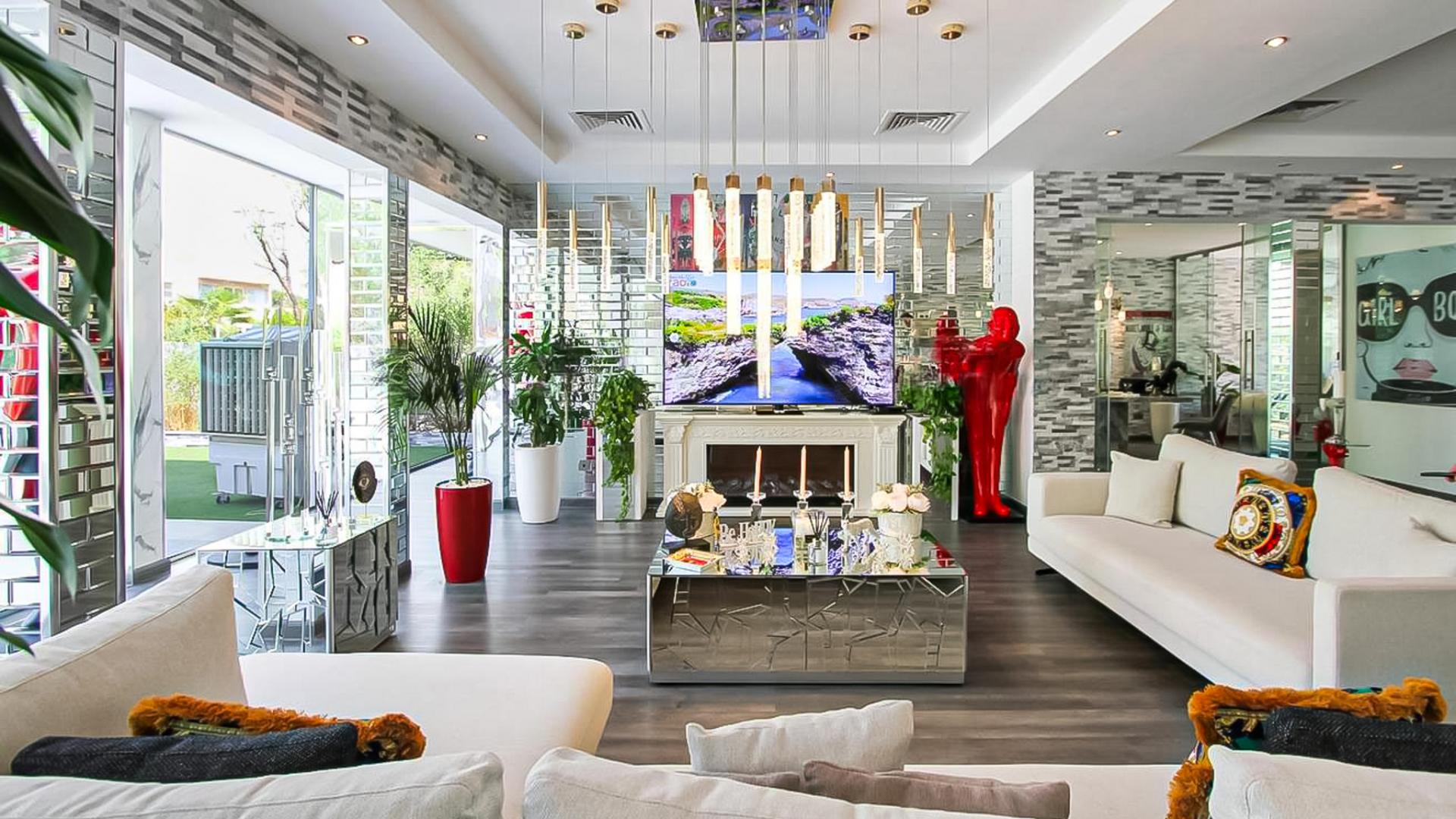 Modern living room in Saheel villa, Arabian Ranches, with stylish decor and large windows